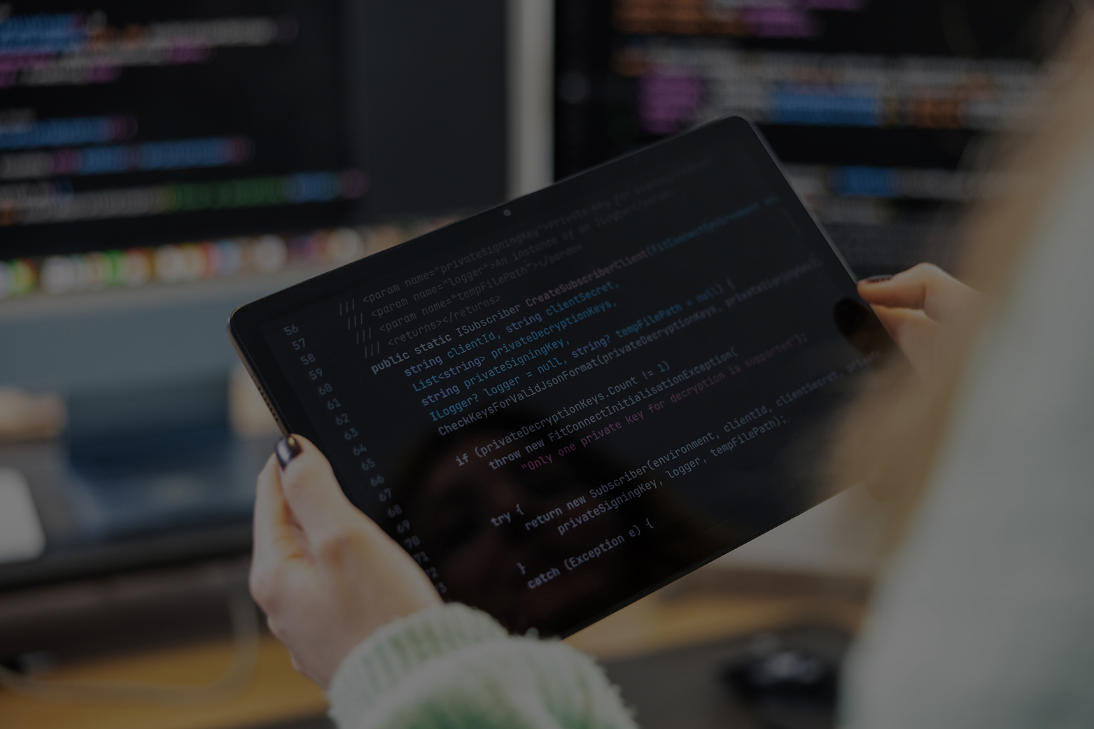 Frau hält ipad in der Hand mit Code.